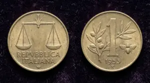 Moneta italiana da 1 lira del 1953 con ape e ramo di ulivo su sfondo scuro